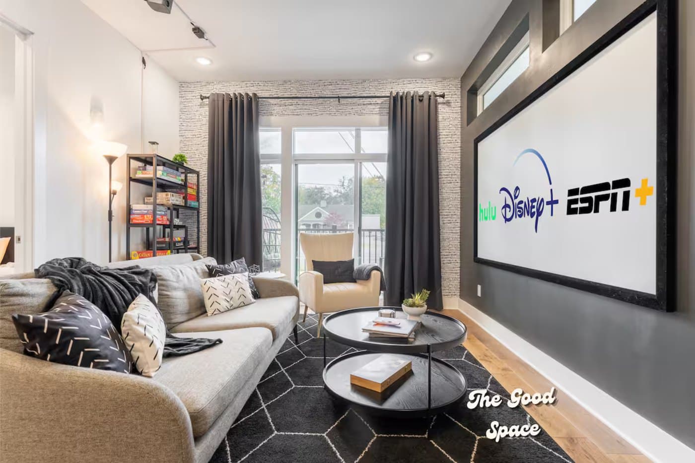 The theater-mural condo: open living room with projector screen and board-game library